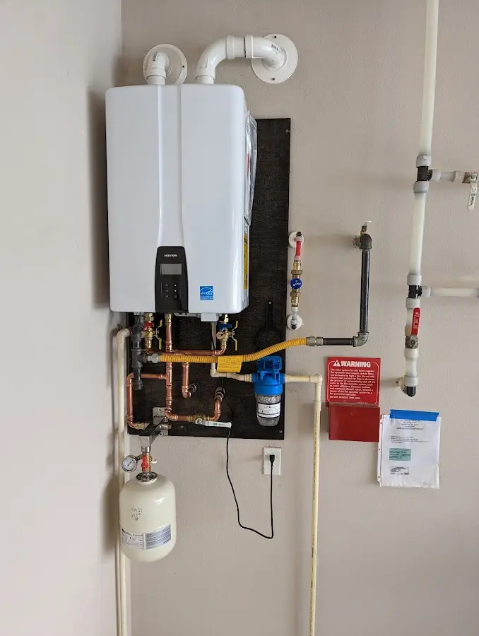 Professional plumber installing copper piping in a Waipahu home